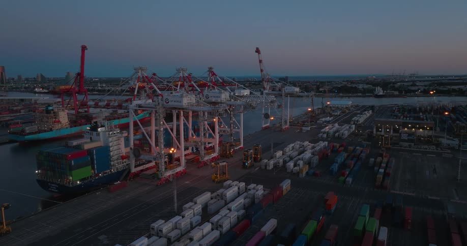 Aerial view of a loading dock with multiple cargo boats and containers