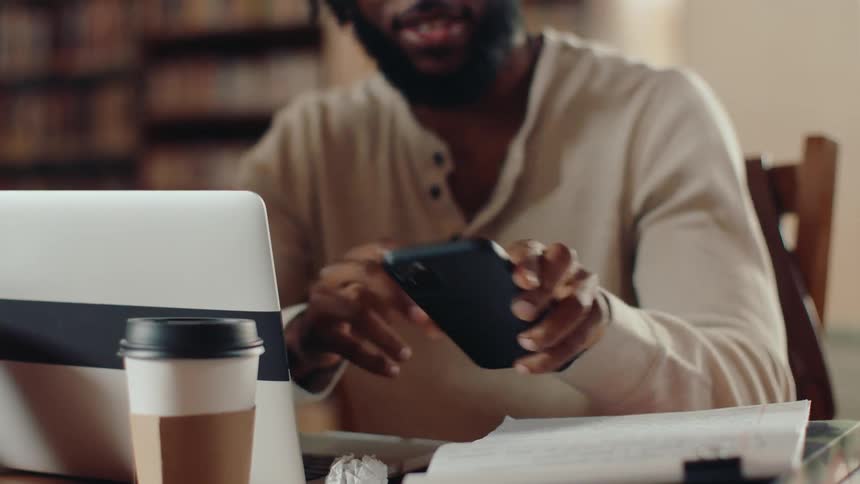 A man looks at his smart phone checking a message