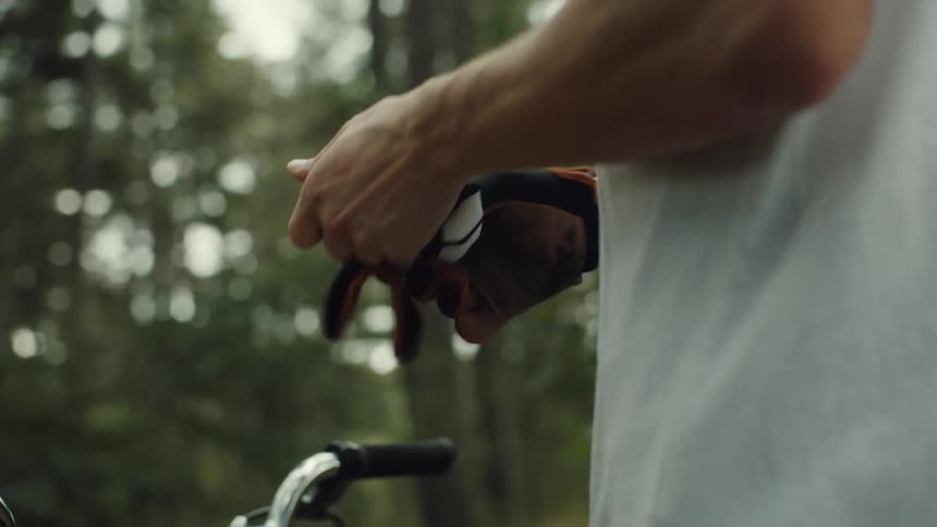 A man puts on his biking gloves
