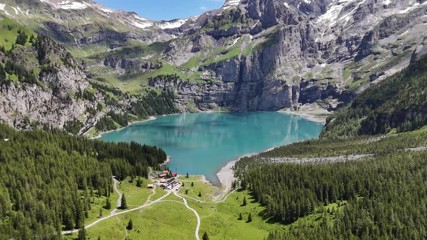 A turquoise lake surrounded by rugged mountains in an alpine valley