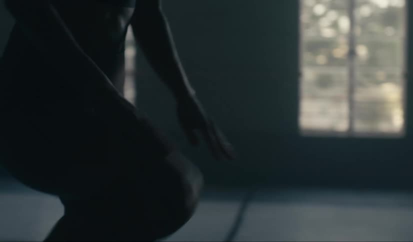 Person clapping palms on knee while exercising indoors