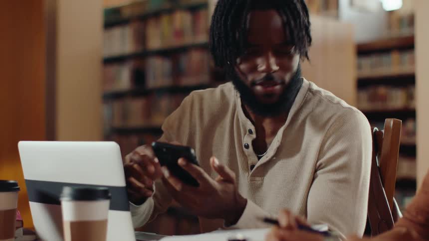 A man pulls out his phone and talks to someone