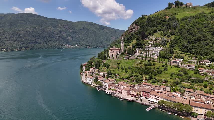 A city with houses of ancient architecture built at the base of a hill facing a bay of water