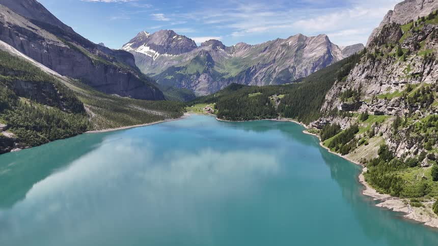 A white male takes in a breathtaking lake and mountain view