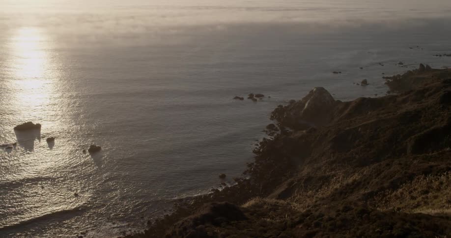 The coast has waves crashing against the shore below