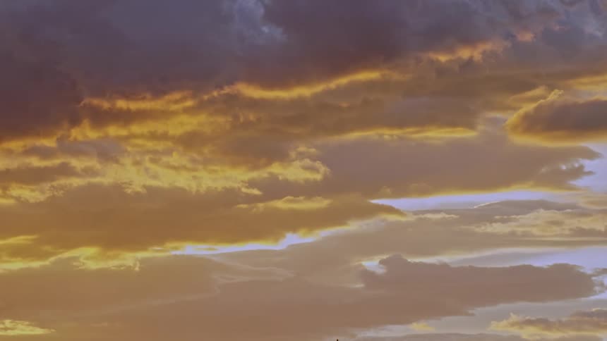 Golden sky with clouds of a dawn