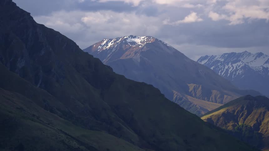 Panorama of mountains with snowy peaks on a cloudy day