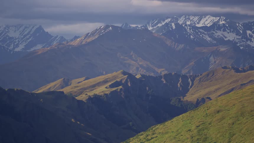 Green mountains with snowcapped peaks