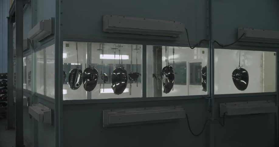Metal parts hanging in a lighted factory
