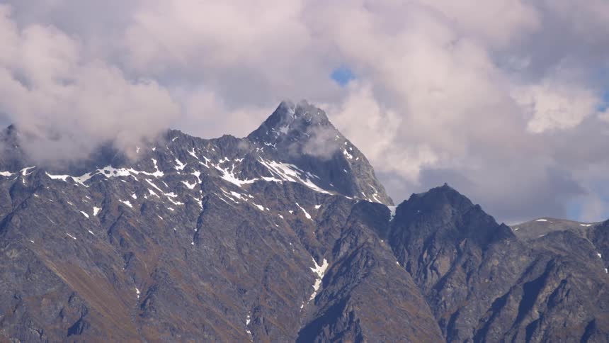 Snowy mountains with clouds above