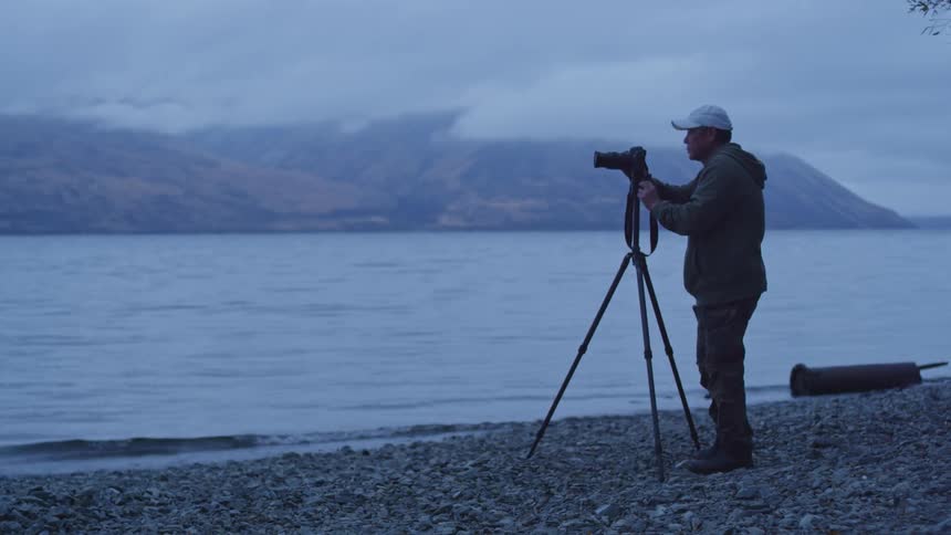 A guy sets up his camera for a shot