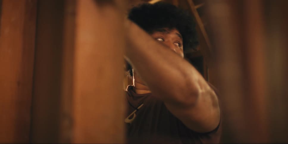 Man examines posts in a wooden framed building