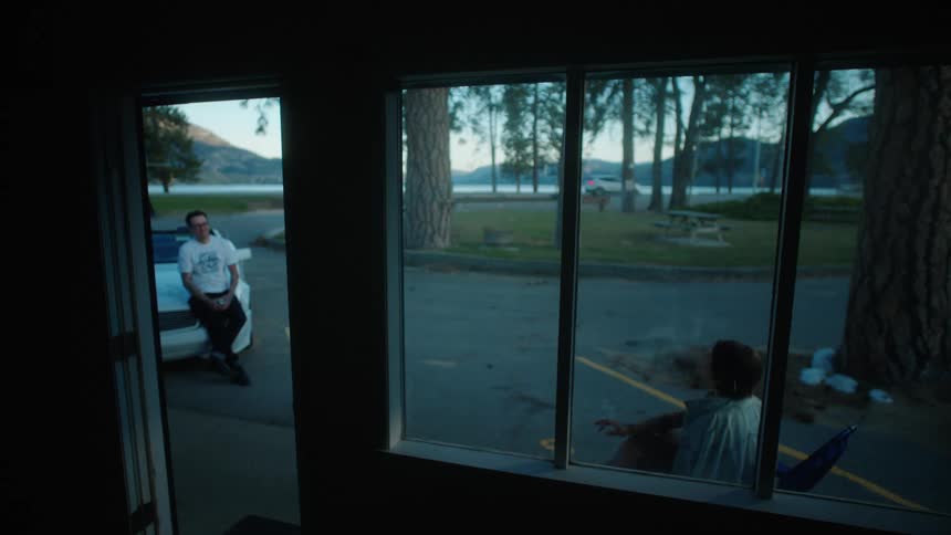 Two people talk and smoke outside