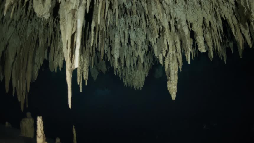Interior of a pointed cave submerged in dark waters