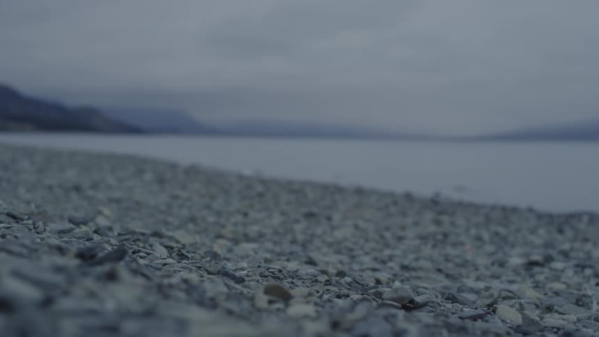 Landscape with rocks on the edge of a lake on a cloudy day