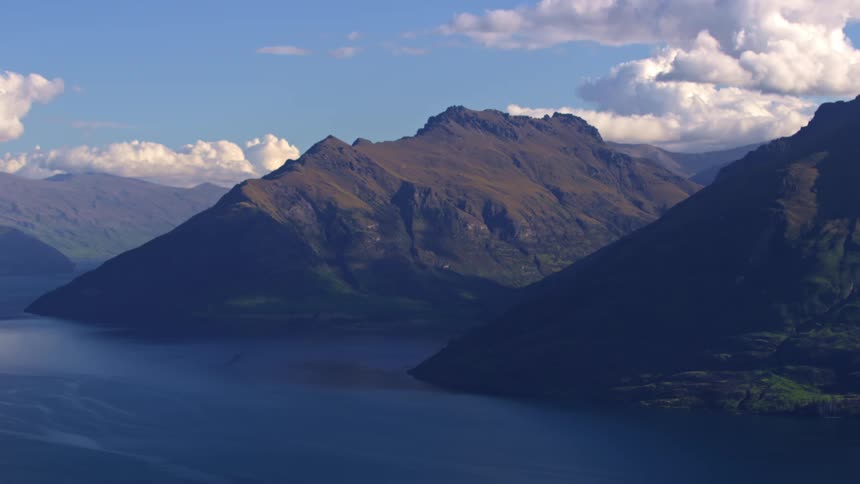 Landscape of large mountains by the blue lake