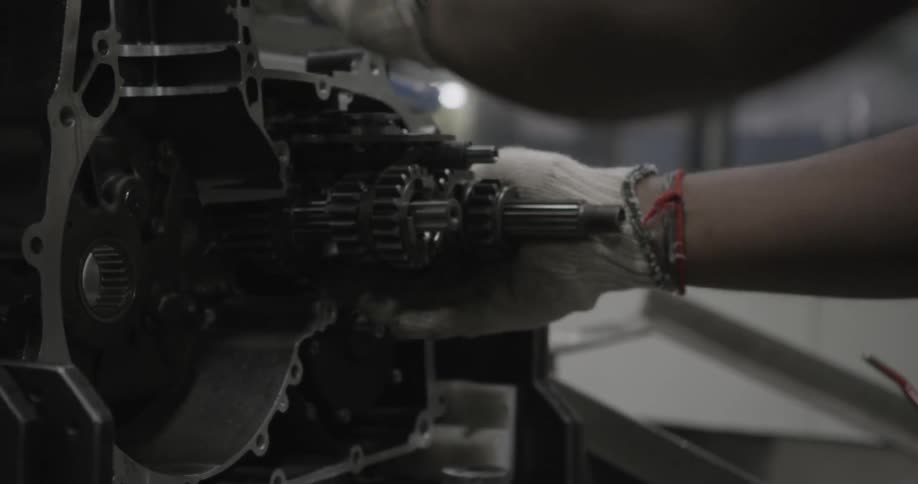 A man adjusts gears on a machine