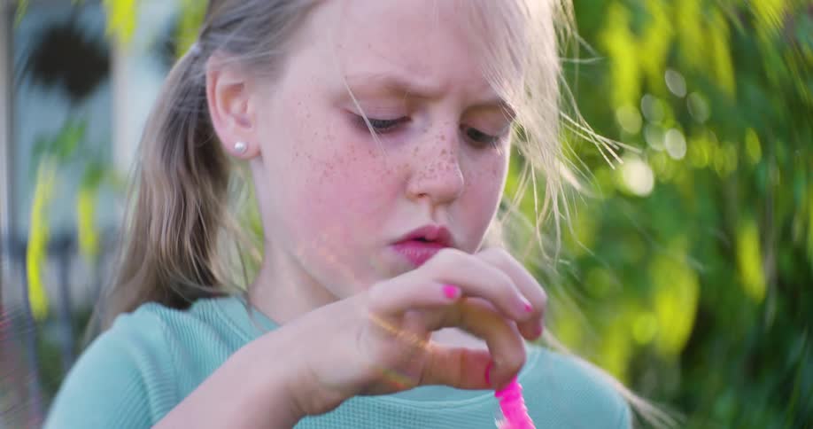 A girl blows bubbles