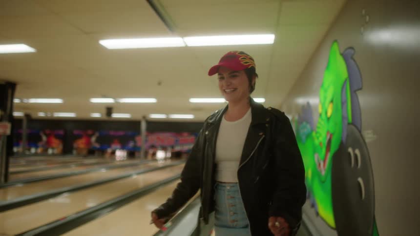 Woman happily vibrating while playing bowling
