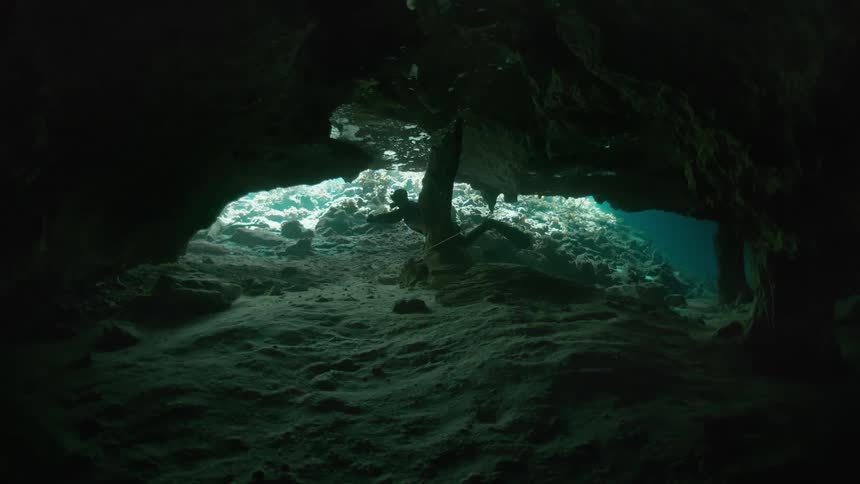 Diver venturing into an underwater cave