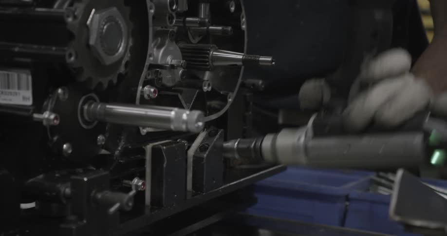 Person using an impact driver on some equipment
