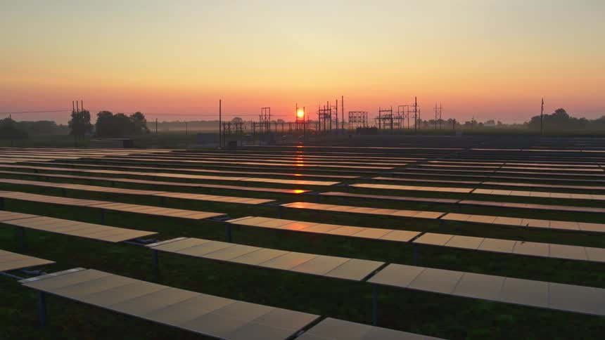 Solar panels reflect sunlight from the setting sun
