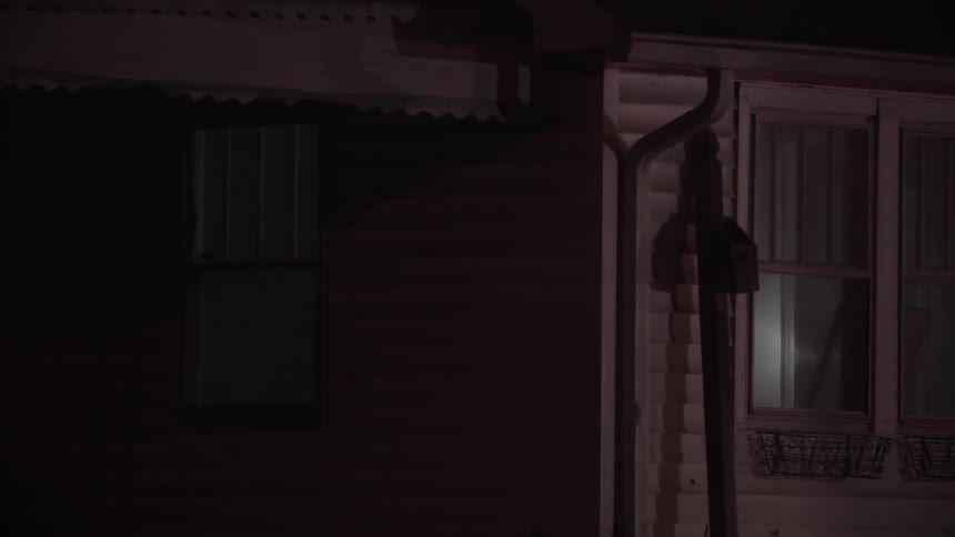 A firefighter with flashlight in a smoky house