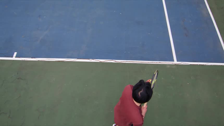 Man throwing a ball with a tennis racket