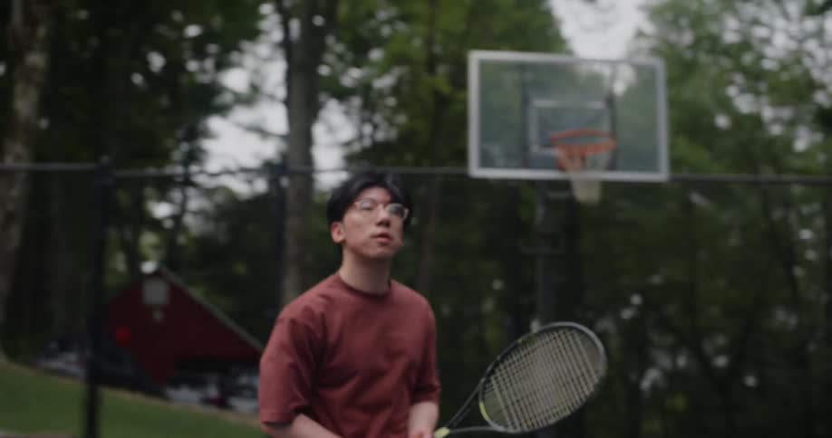 Young man running back and forth playing tennis