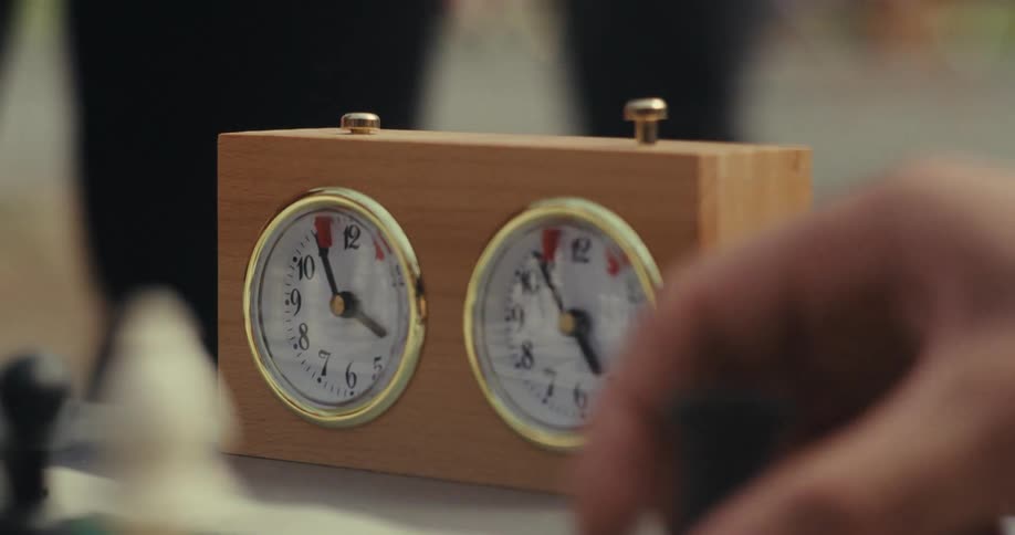 Chess players make moves and press the timer