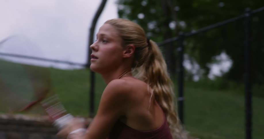 Woman running and playing tennis on a court