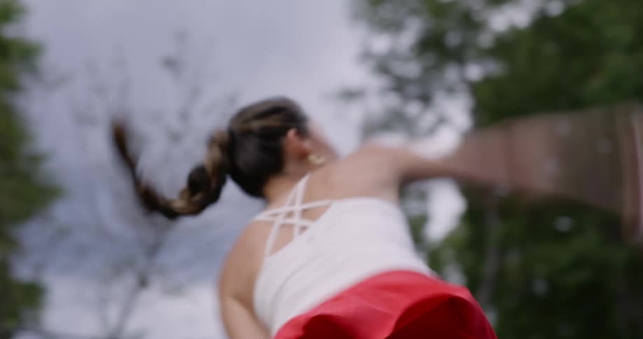 A woman hits a tennis ball with a racket