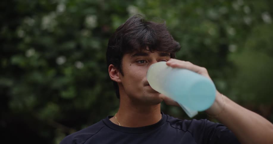 A man drinks from a thermos