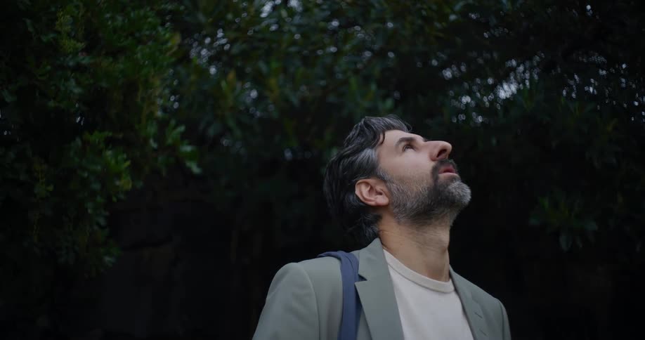 Man taking a deep breath and looking up