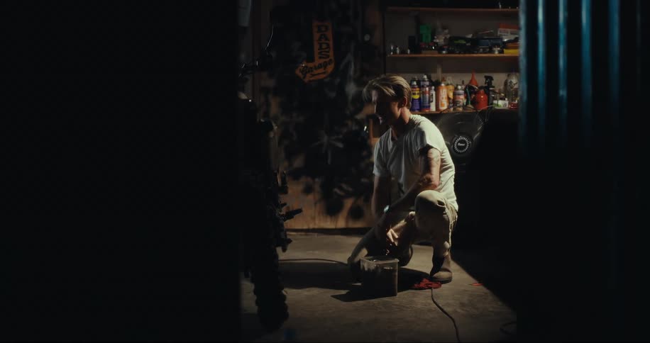 A man working on something in a dark garage