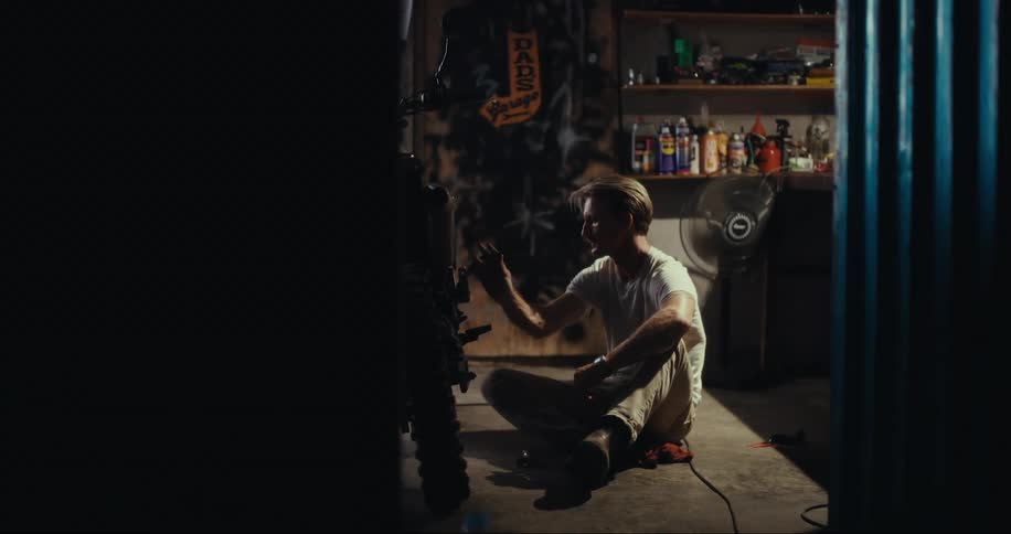 A man tinkers in a workshop
