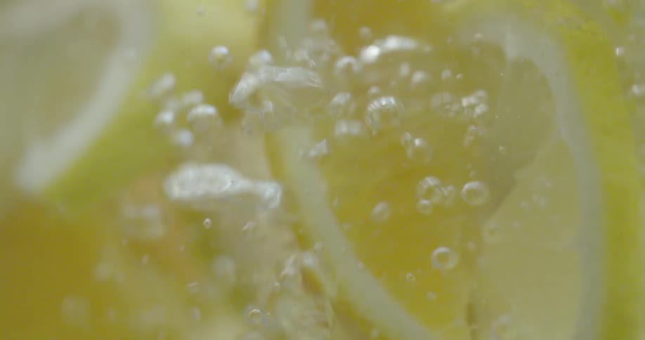Lemon wedges are bubbling inside a clear liquid
