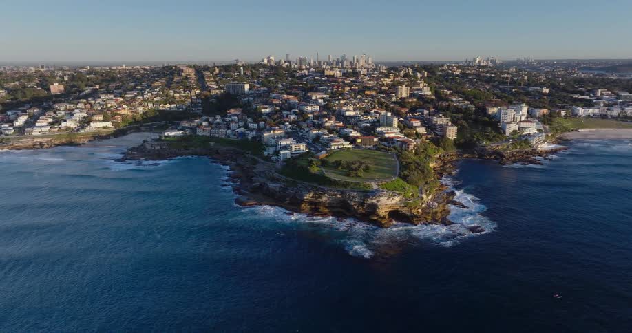 Aerial view of the coastline of a city next to the ocean