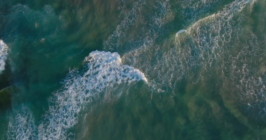 Top down aerial view of ocean waves near the coast
