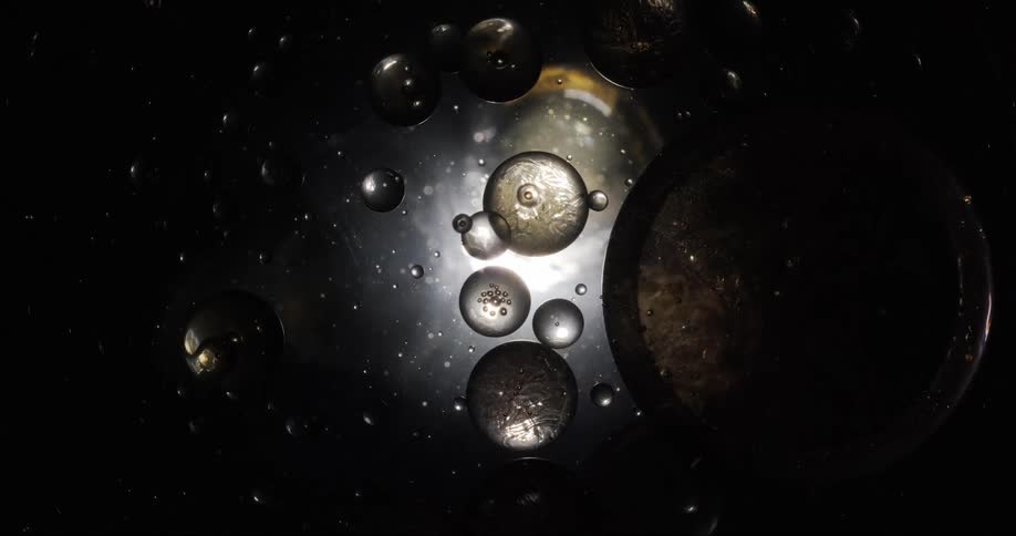 Bubbles of different sizes shapes and colors flow into each other and merge