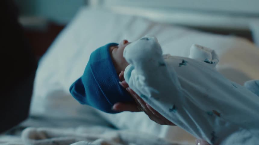 Person holding a newborn baby