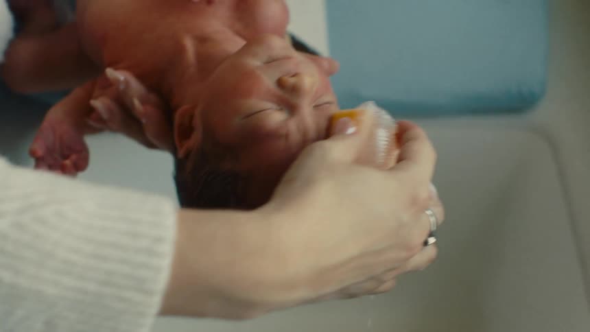 Newborn baby taking a bath
