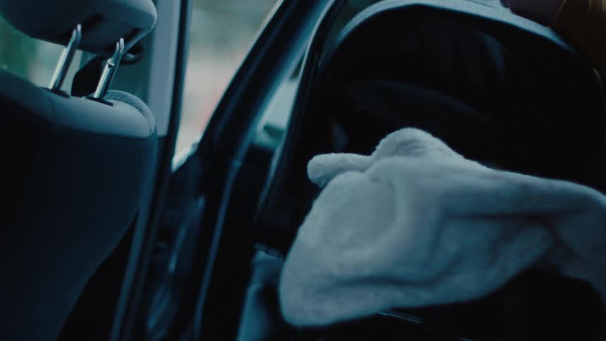Man taking a mobile crib from inside the car