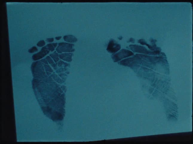 Sheet of paper with two baby footprints