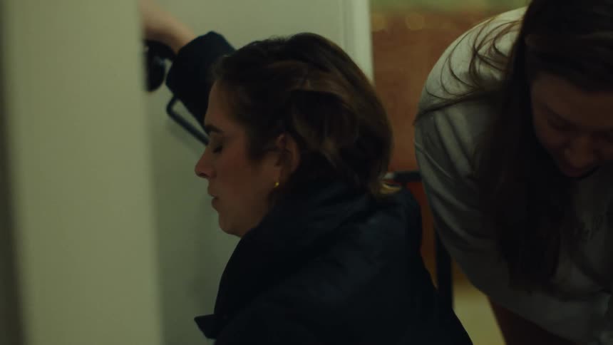 Two women working together on a task indoors