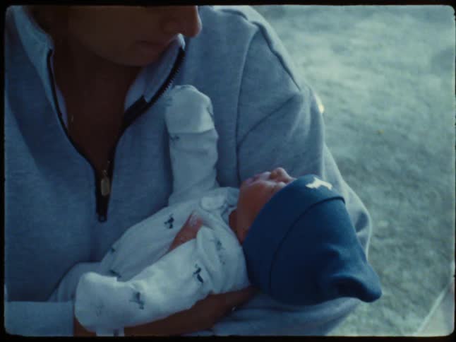 Mother holding her newborn baby in her arms
