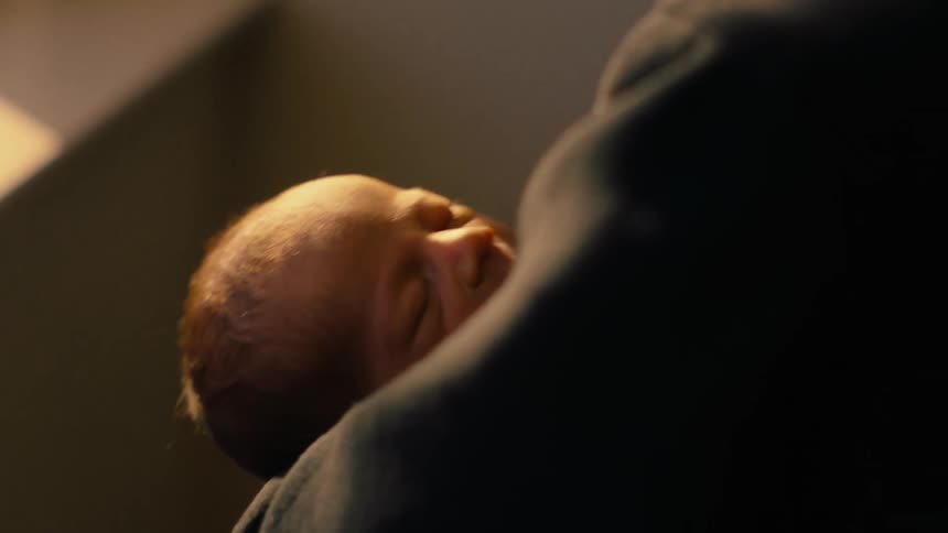 A person holding a baby in their arms