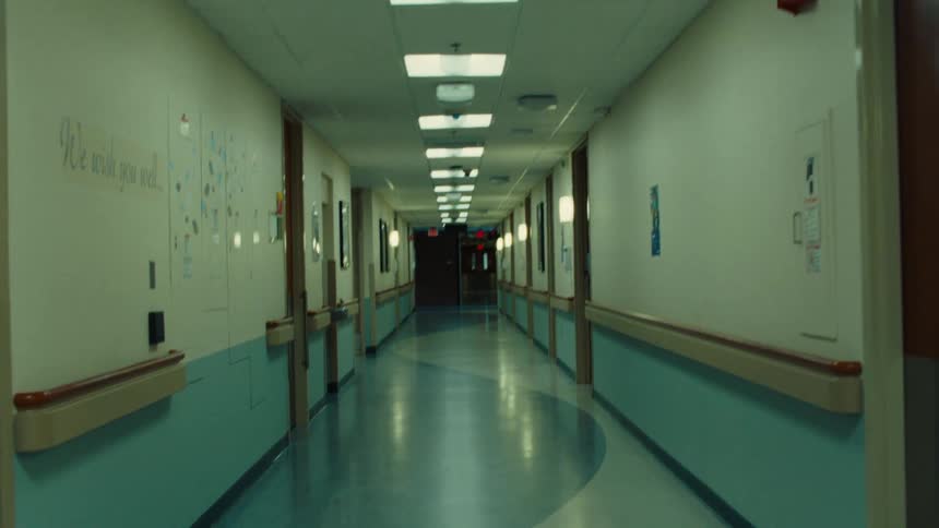 A hallway with blue and white walls and a wave design on the floor
