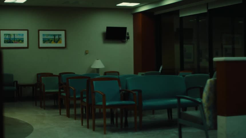 Hospital waiting room with empty chairs at night