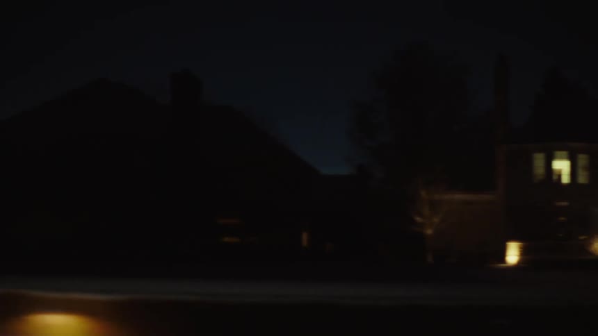 Houses lit up at night in a residential neighborhood